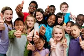Group of diverse, smiling children giving a thumbs-up.