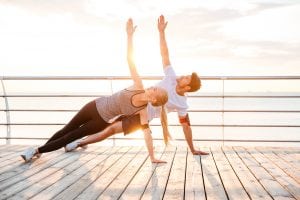 bigstock Smiling couple doing yoga exer 151089923